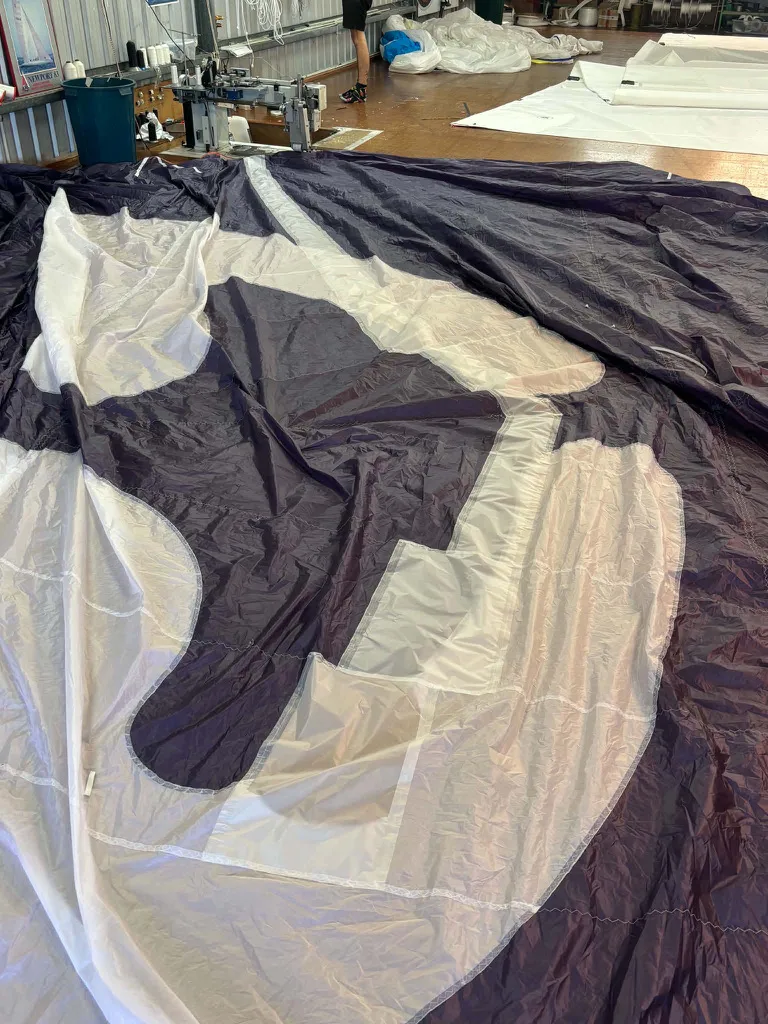The purple spinnaker back in the sail loft for repair